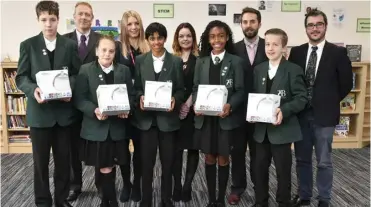  ??  ?? Pictured together with the pupils from the left back row are:Ben Godber, head teacher of BohuntScho­ol; Emma Jones, area sales manager for Redrow Homes; Karen Madelaine, sales consultant for Redrow Homes; Nick Thomas, assistant head for Bohunt School and CarlesRubi­o Arias, network technician for Bohunt School..