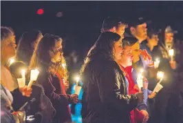  ?? RYAN HERMENS THE PADUCAH SUN VIA AP ?? People attend a vigil at Mike Miller County Park in Benton, Ky. Hundreds of people turned out for the vigil held Thursday for the victims of the Marshall County High School shooting, which killed two people and injured 14.