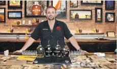  ??  ?? Shawn Martin creates craft rums at Hemingway Rum Company distillery in Key West, where bottles are shaped like military water canteens.