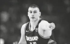  ?? DAVID ZALUBOWSKI/AP ?? DENVER NUGGETS CENTER NIKOLA JOKIC gestures after hitting a 3-point basket against the Golden State Warriors in the first half of Game 4 of a first-round Western Conference playoff series on April 24 in Denver.