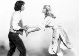  ?? SENTINEL FILE PHOTO ?? Michael Beck, left, and Olivia Newton-John starred in the 1980 film “Xanadu.” The boxoffice flop inspired a stage adaptation, which is headed to the Garden Theatre.