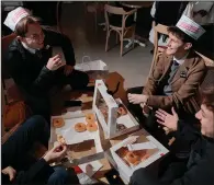  ?? (The New York Times/Violette Franchi) ?? Austin Eggett (bottom left), Christophe­r Policky, Isaac Rolls and Caden Beames, students from the United States who will be living in Paris for two years, eat at the Krispy Kreme in Paris onWednesda­y.