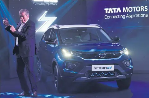  ?? AFP ?? Guenter Butschek, CEO and managing director of Tata Motors Worldwide, gestures during the launch of the Nexon EV in Mumbai on Tuesday.