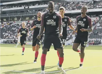  ??  ?? Mo Eisa celebrates a goal for Posh at MK Dons in 2019.