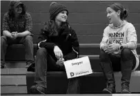  ?? JIM WATSON/GETTY-AFP ?? A supporter of Democratic presidenti­al candidate Elizabeth Warren, right, tries to get a supporter of Tom Steyer to switch sides.