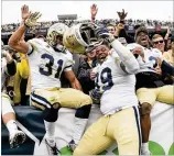  ?? CONTRIBUTE­D BY JOHN AMIS ?? Jackets including Nathan Cottrell (31), Antwan Owens (89) and Tre Swilling celebrate Saturday’s win at Bobby Dodd Stadium.