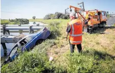  ??  ?? The car was winched from the Karamu Stream but the family who were in it left the crash scene on Thursday night.