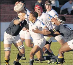  ?? Picture: BRIAN WITBOOI ?? COMING THROUGH: Grey High’s Renaldo Pedro is tackled by Graeme College players Donovan Britz, left, and Thandwefik­a Mgidlana during their match at Grey yesterday