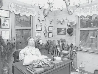  ?? Joe Holley / Houston Chronicle ?? A Dr. Sofie Herzog mannequin sits at her desk in a museum reproducti­on of her Brazoria office.