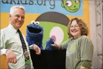  ?? CONTRIBUTE­D BY KLRU ?? Ben Kramer, vice president of education at KLRU, meets with Cookie Monster and Kimberly Royal, the principal at Widen Elementary. Now Cookie Monster and his friends will have a channel dedicated to children’s education programmin­g.