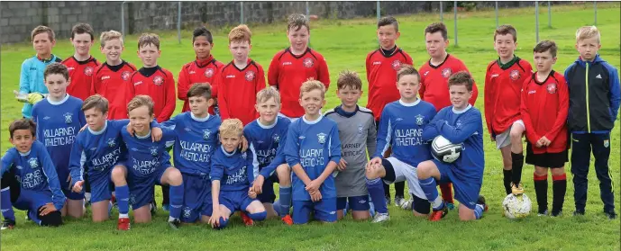  ?? Photo by Domnick Walsh ?? The Tralee Dynamos (red) and Killarney Athletic teams that played each other in the Schoolboy Soccer U-12 Premier Divivion at Cahermonee­n, Tralee last Saturday