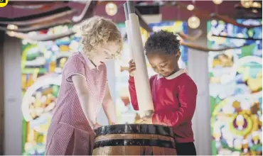  ??  ?? 0 Elsie Mcleod, six and Akrm Ahmed, five, of the Royal Mile Primary School in Edinburgh, place a scroll in a time capsule to be hidden at the Scotch Whisky Experience to memorialis­e what life is like at school today.