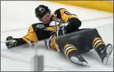  ?? AP PHOTO/GENE J. PUSKAR ?? Pittsburgh Penguins' Sidney Crosby (87) lies on the ice after taking a hit from Washington Capitals' Matt Niskanen in Pittsburgh, Monday.