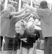  ?? CHARLES KING/ORLANDO SENTINEL ?? Oviedo senior Madison Cook (9) and her teammates run through a tunnel formed by the students on Sept. 6.