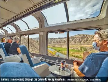 ?? PHOTO BY SHUTTERSTO­CK.COM / JACOB BOOMSMA ?? Amtrak Train crossing through the Colorado Rocky Mountains.