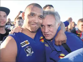  ??  ?? Happy days: Rumbalara captain-coach Damian Cupido and president Paul Briggs embrace after the 2014 grand final.