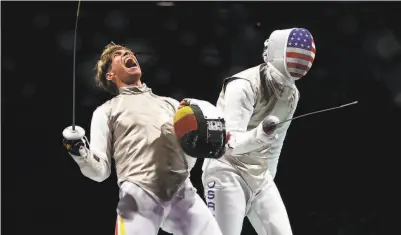  ?? Elsa / Getty Images ?? Germany’s Peter Joppich celebrates his victory over threetime Olympian Alexander Massialas.