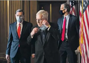  ?? Rod Lamkey Pool Photo ?? SEN. JOHN THUNE ( R- S. D.), right, with leader Mitch McConnell and Sen. John Barrasso ( R- Wyo.), said future COVID- 19 aid might not be needed “if we address the critical needs right now, and things improve.”