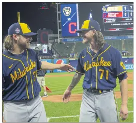  ?? PHIL LONG — THE ASSOCIATED PRESS ?? Milwaukee Brewers starter Corbin Burnes, left, and reliever Josh Hader celebrate after pitching a combined no-hitter against the Cleveland Indians on Saturday night.