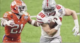  ?? Sean Gardner / Getty Images ?? Jeremy Ruckert (88) of Ohio State carries the ball against Malcolm Greene of Clemson in the first half during the College Football Playoff semifinal game at the Allstate Sugar Bowl at Mercedes-benz Superdome in New Orleans, Louisiana. The game finished too late for this edition. For a complete story, go to http://timesunion.com.