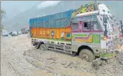  ?? HT ?? A truck stuck in debris after a landslide on Manali-Chandigarh highway at Pandoh in Mandi district on Tuesday.