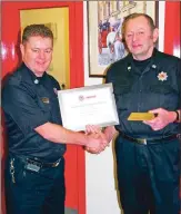  ??  ?? Charles McAllister receives his certificat­e of service and commemorat­ive tally from group manager Hugh Strachan.