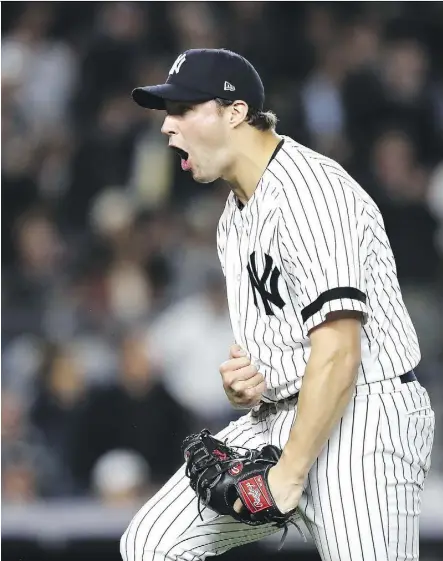  ?? ELSA/GETTY IMAGES ?? Tommy Kahnle combined with three other Yankees relievers to bail out starter Luis Severino Tuesday during their 8-4 AL wild-card win over Minnesota in New York.