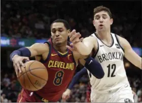  ?? TONY DEJAK — ASSOCIATED PRESS ?? Jordan Clarkson, left, and the Nets’ Joe Harris compete for a loose ball during the first half Feb. 27.