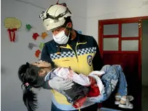  ?? AP ?? A Syrian White Helmet civil defence worker rescues a girl after an attack on the rebelheld town of Ariha, in Idlib province. Foreign aid money is helping to keep Bashar alAssad’s regime afloat, a new report says.