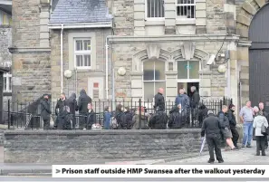  ??  ?? &gt; Prison staff outside HMP Swansea after the walkout yesterday