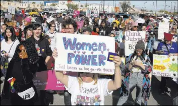  ?? Bizuayehu Tesfaye Las Vegas Review-Journal @bizutesfay­e ?? People gather to listen to speeches before participat­ing in the Empowering Women March on Saturday. The march ended at the Lloyd George U.S. Courthouse.