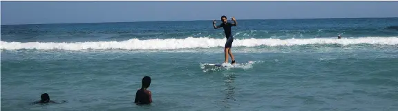  ?? PHOTOS: RENÉ BRUEMMER ?? The Haiti Surf school, east of the seaside resort town of Jacmel, offers tourists the chance to catch some waves with the help of friendly local instructor­s.