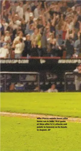  ?? AP ?? Mike Piazza rounds bases after home run in Mets’ first game at Shea after 9/11 attacks and points to heavens as he heads to dugout.