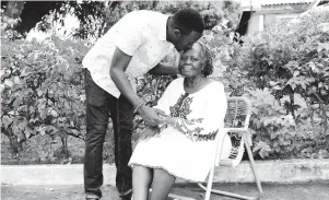  ??  ?? Fredlin Tomlin and her foster son, Randy, whom she took in at age six, share a loving moment outside their home in May Pen, Clarendon, on Valentine’s Day.