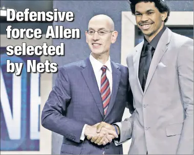  ?? EPA ?? SHAKE IT UP: Jarrett Allen is all smiles shaking NBA Commission­er Adam Silver’s hand Thursday night at Barclays Center. Allen, the 22nd pick by the Nets, is a 6-foot-11 center who will provide a desperatel­y needed defensive presence to the NBA’s worst...