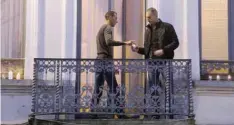  ??  ?? BRUSSELS: Mohammad Abdeslam (left), the brother of Paris attackers Salah and Brahim Abdelslam, lights candles with an unidentifi­ed man on the balcony of his house during a candleligh­t vigil in the town square of Molenbeek, Belgium. — AP