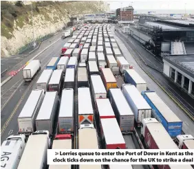  ??  ?? > Lorries queue to enter the Port of Dover in Kent as the clock ticks down on the chance for the UK to strike a deal