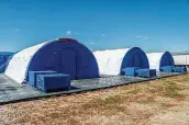  ?? Sergio Flores / Washington Post contributo­r ?? Intensive care tents sit in a row at the facility. HHS has 13,200 beds for children.