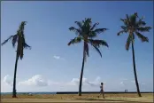  ?? MARCO GARCIA — THE ASSOCIATED PRESS ?? A person walks down Waikiki Beach in Honolulu.