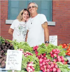  ??  ?? Ruth Gatke, left, and husband Marc McKerrache­r have been selling organic produce at Welland Farmers' Market for the past four years.