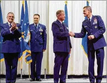  ??  ?? Brig. Gen. James H. Dienst (center), 711th Human Performanc­e Wing commander, shakes hands with Brig. Gen. Mark Koeniger, June
21, a few seconds after assuming command of the wing during a ceremony presided over by Maj. Gen. William T. Cooley, Air Force Research Laboratory commander, in the National Museum of the U.S. Air Force. Dienst took over command from Koeniger who had commanded the wing for the past three years.
