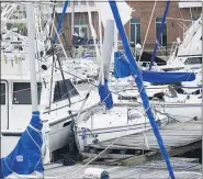  ??  ?? Storm damaged boats sit at the dock in a marina, Sept. 17, in Pensacola, Florida. Rivers swollen by Hurricane Sally’s rains threatened more misery for parts of the Florida Panhandle and south Alabama Sept. 17, as the storm’s remnants continued to dump heavy rains inland that spread the threat of flooding to Georgia and the Carolinas.