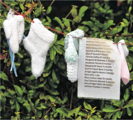  ?? PHOTO: RAY RYAN ?? Tragic: Names of children who died at the Tuam Mother and Baby Home with knitted babies’ socks.