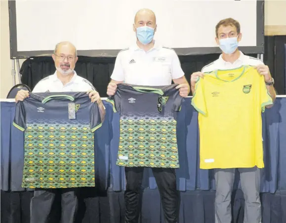  ?? (Photo: Dwayne Richards) ?? Union of European Football Associatio­ns (UEFA) Assist internatio­nal experts (from left) Pedro Correia, Kenny Macleod, and Chris Milnes display Reggae Boyz jerseys they received on Friday, October 8, 2021 after they delivered the Capacity Building Workshop to the Jamaica Premier League clubs during a week-long exercise at Jamaica Pegasus hotel in Kingston.