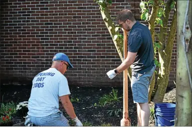  ?? MEDIANEWS GROUP FILE PHOTO ?? Volunteers work on landscapin­g, painting and picking up trash along the areas of Beech Street, Grant Street and Walnut Street in Pottstown. The cleanup was part of The Hill School’s Reunion Weekend and included volunteers from Spring Valley Community Church.