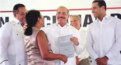  ??  ?? El presidente Danilo Medina, acompañado del director del IAD, Emilio Toribio Olivo, y de José Dantés Díaz, director de la Comisión Permanente de Titulación de Terrenos del Estado, entregó ayer 923 títulos definitivo­s de parcelas y solares a igual...