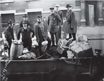  ??  ?? Boston police with seized radical literature, November 1919