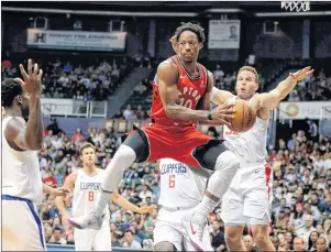  ?? AP PHOTO ?? In this Oct. 3 file photo, Toronto Raptors guard DeMar DeRozan (centre) makes a pass through the Los Angeles Clippers defense during the first quarter of a preseason NBA game in Honolulu.