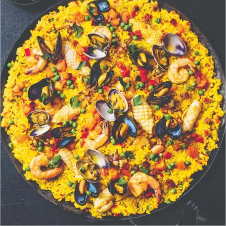  ?? FIGURE 1 PUBLISHING ?? A paella packed with seafood and chorizo is among the “timeless” dishes featured in Gather by David Robertson.