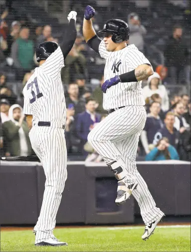  ?? Elsa / Getty Images ?? Gary Sanchez, right, of the Yankees is greeted by Aaron Hicks after Sanchez hit a two-run home run in the seventh inning of Tuesday night’s game against the Twins at Yankee Stadium in the New York.